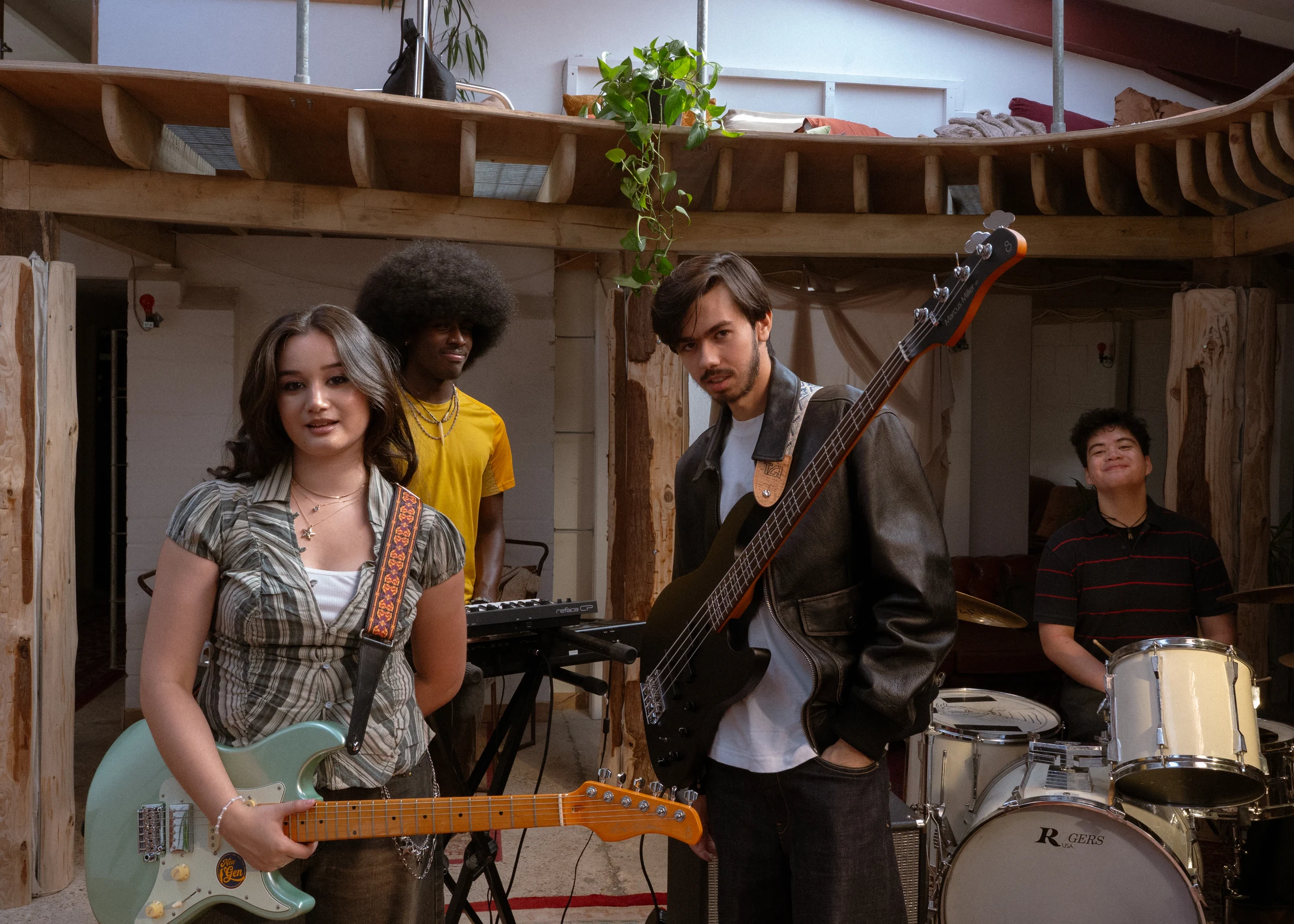 Clarissa Mae and her band with their instruments on the bed crumbs video set at Bean World Studios.
