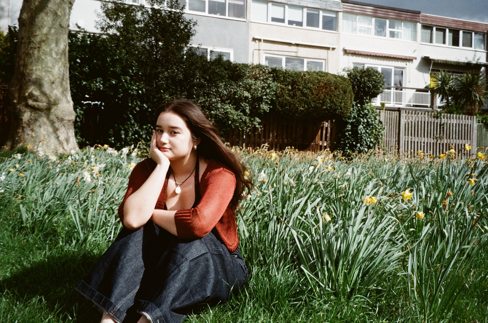 Clarissa Mae sitting near flowers