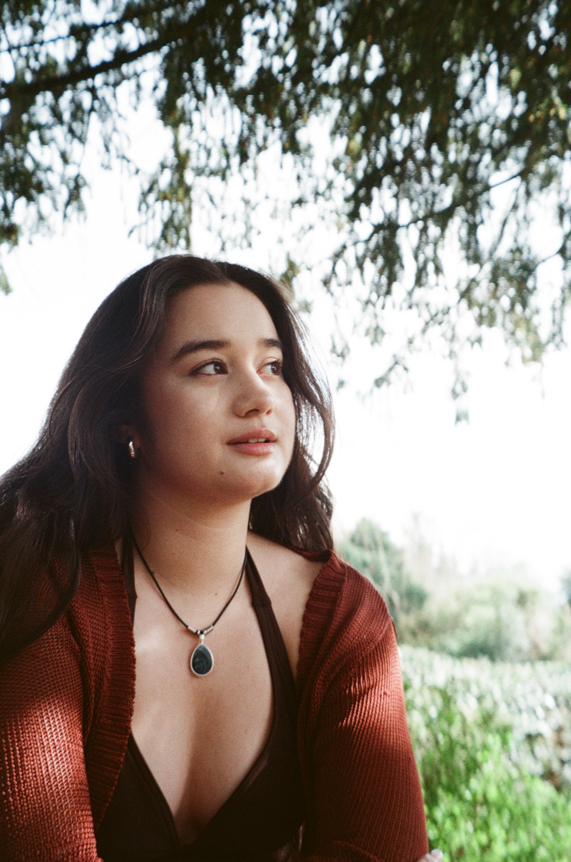 Clarissa Mae looking toward the light under tree branches
